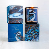 A set of three Australian Sandalwood candles with matte black containers and blue labels featuring artwork of a kookaburra. One candle is placed in front, and the others are stacked behind, with a box in the background.