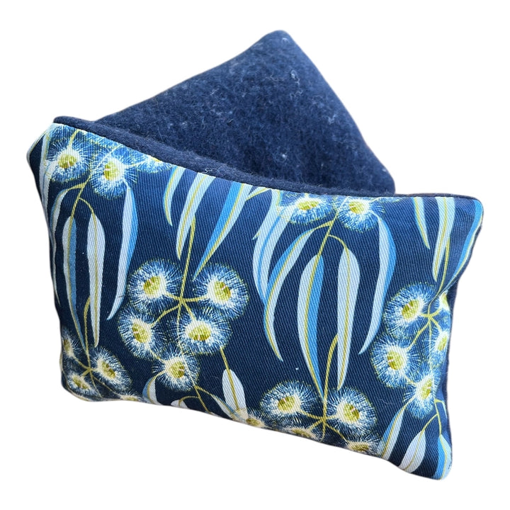 Floral patterned fabric heat pack on a white background