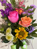 Bouquet of colorful flowers including roses, sunflowers, and other varieties.