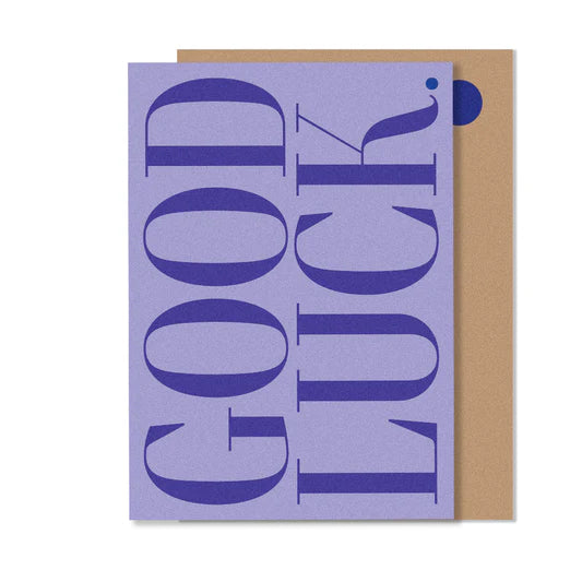 A greeting card with a purple background and the text 'GOOD LUCK' in large white letters, followed by a small blue dot.