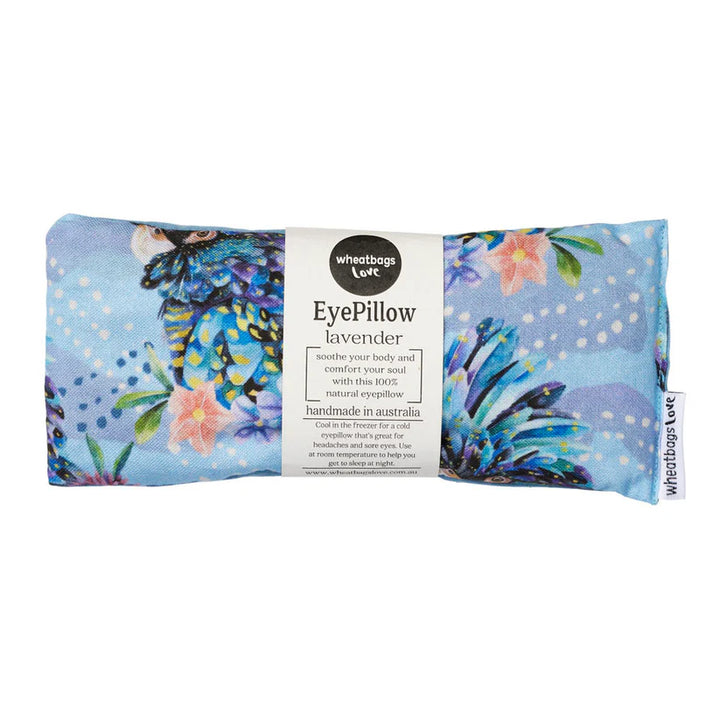 A rectangular eye pillow with a blue cockatoo design, including pink flowers and leaves, against a white background. The product packaging indicates it is filled with lavender and suitable for relaxation.
