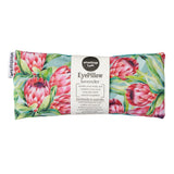A rectangular eye pillow with a floral protea design, including pink flowers and leaves, against a white background. The product packaging indicates it is filled with lavender and suitable for relaxation.