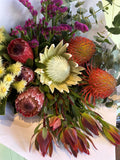 Bouquet of proteas and other flowers on a white background