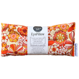 A rectangular eye pillow with a vibrant floral pattern in shades of orange and yellow, featuring product information and branding on a label.