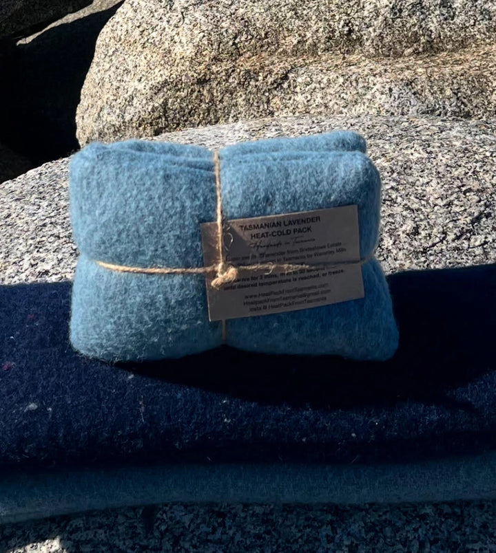 Blue heat-cold pack with a label on a textured surface