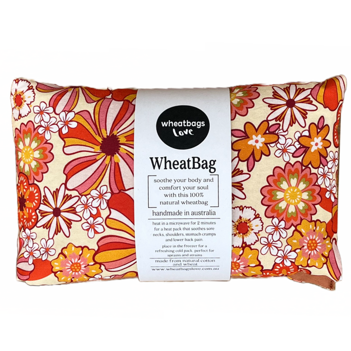 Wheatbag in a bright orange floral print on a plain white background