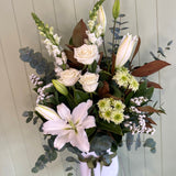 Bouquet of flowers with white and green colors against a light wooden panel background