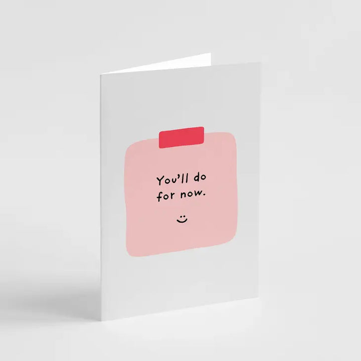 A white greeting card with a pink bandage illustration and the text 'You'll do for now.'