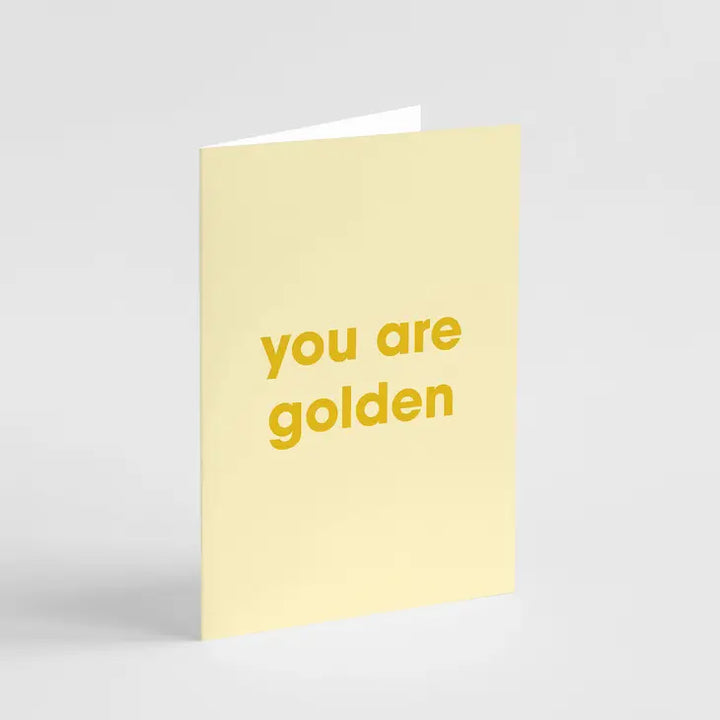 A yellow greeting card with the text 'you are golden' printed in a bold, yellow font.