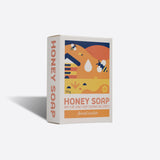 Box of honey soap with a colourful bee design on a white background