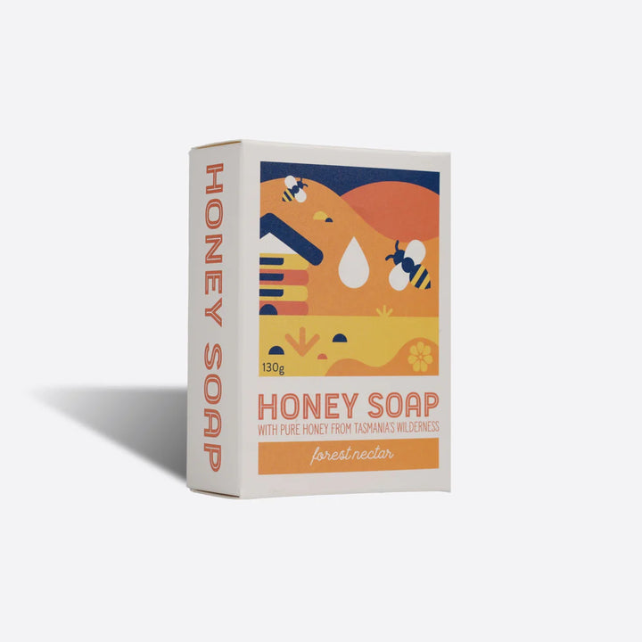 Box of honey soap with a colourful bee design on a white background