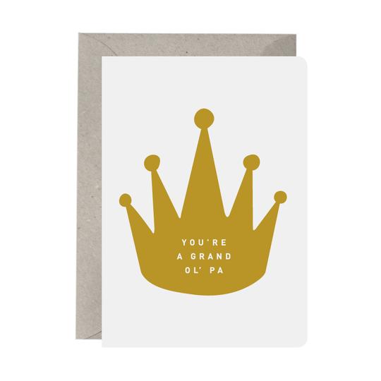 A greeting card with a graphic of a crown and the text 'YOU'RE A GRAND OL' PA' on it, accompanied by a natural color envelope.