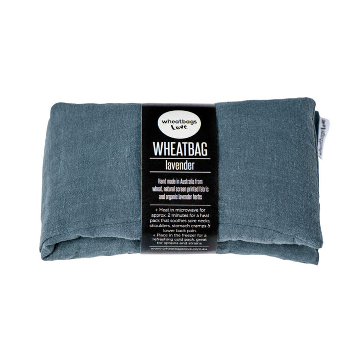 A rectangular gray linen wheatbag with a label that reads 'WHEATBAG - LAVENDER'.