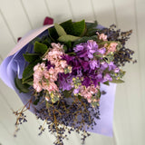 Bouquet of flowers with purple and pink flowers on a white background
