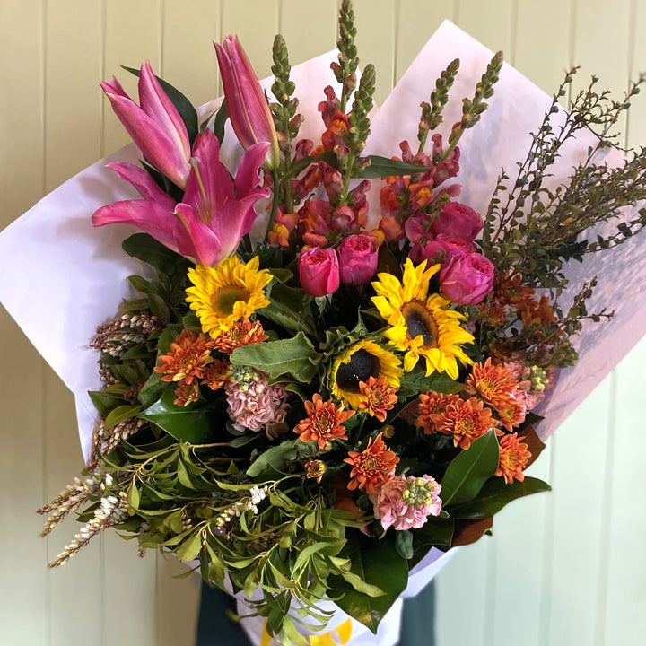 Bouquet of colorful flowers with pink, yellow, and green colors on a white background.