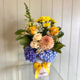 Bouquet of flowers with yellow, orange, and blue colors on a white background