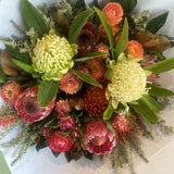 Bouquet of flowers with green, pink, and orange colors on a white background