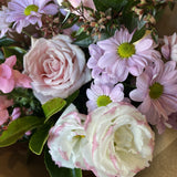 Bouquet of pink and white flowers with green leaves
