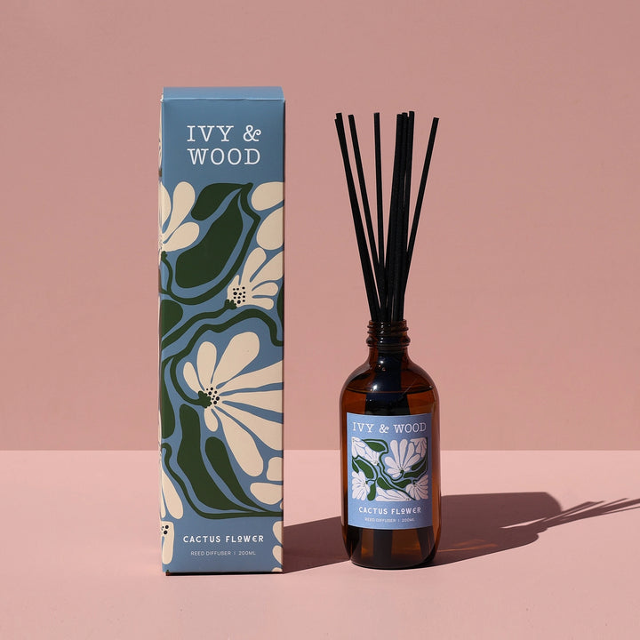 Ivy & Wood diffuser bottle and packaging on a pink background