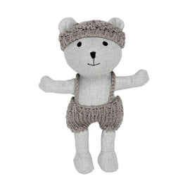 Grey linen plush toy depicting a bear wearing knitted hat and shorts