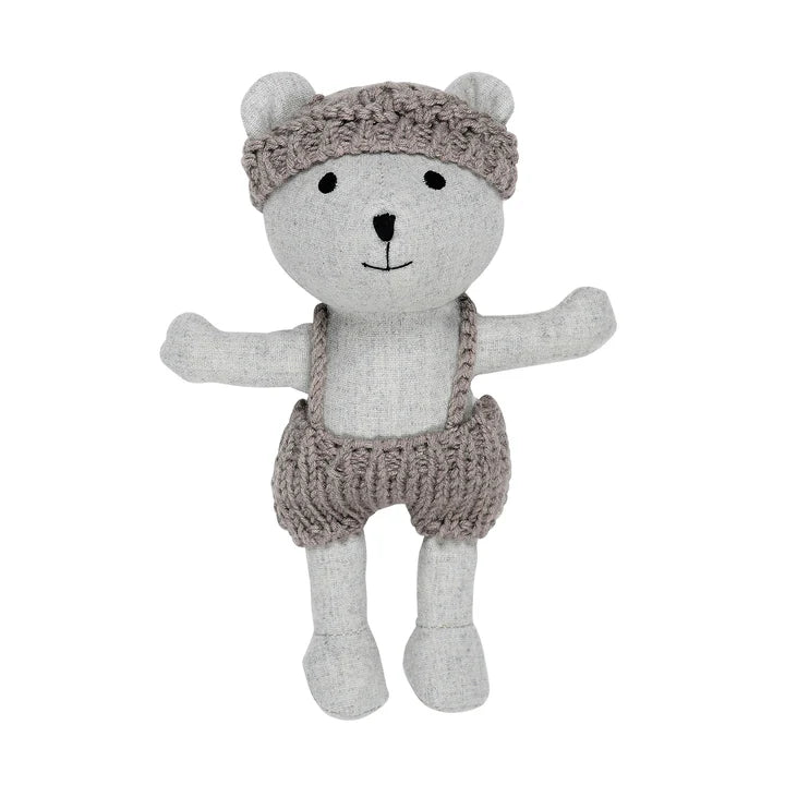 Grey linen plush toy depicting a bear wearing knitted hat and shorts