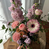 Soft pastel flower arrangement in a petite ceramic pot