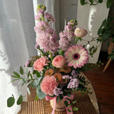 Soft pastel flower arrangement in a petite ceramic pot