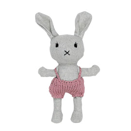 Gray plush bunny toy with pink knitted overalls on a white background