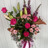 Bouquet of flowers with pink and purple tones against a white background