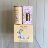 Monista tea packaging including a canister and a box on a white background