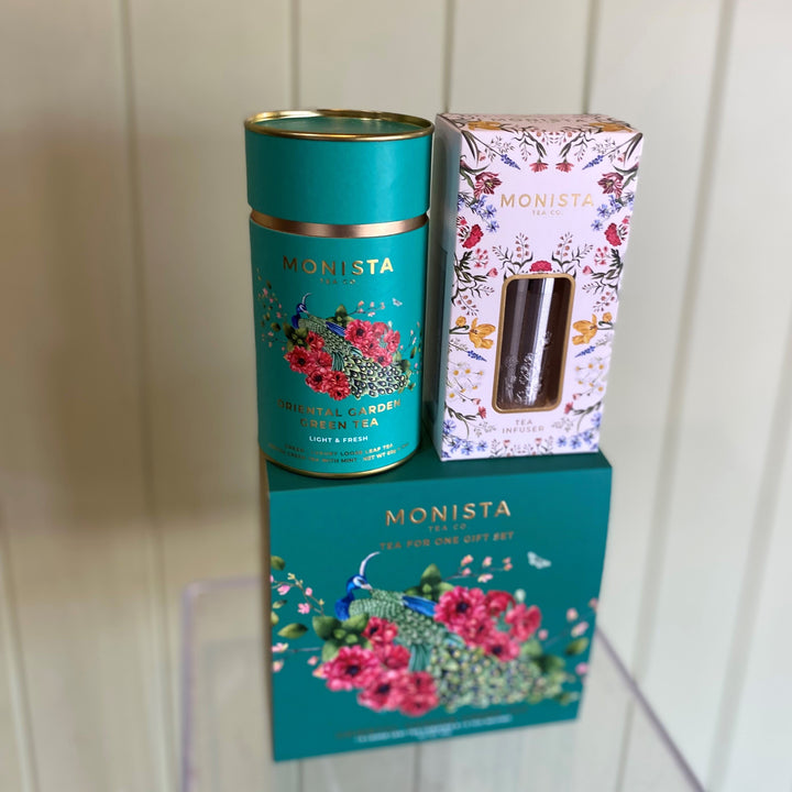 Monista tea canister and packaging on a wooden surface