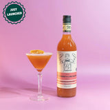 Bottle of cocktail mixer with a labeled cocktail on a pink background, featuring 'JUST LAUNCHED' text.