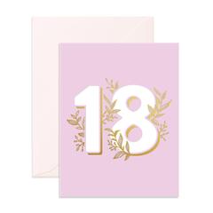 The 18 GREETING CARD by Fox and Fallow features the number "18" prominently displayed in white with gold floral decorations. The light pink background enhances its elegance. Crafted in Australia, this card comes with an envelope positioned behind it, perfect for adding a personal message.